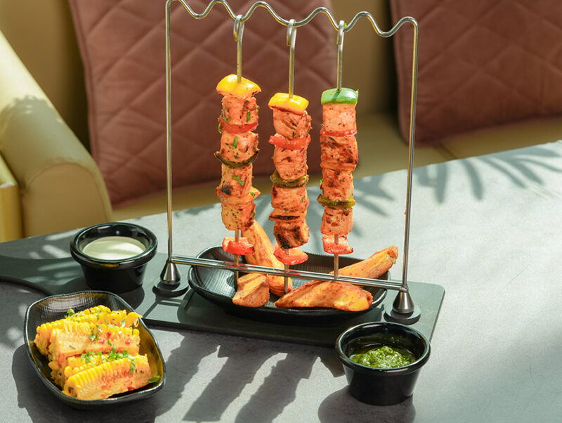 Chicken skewers with cheesy potato and chilli corn rib